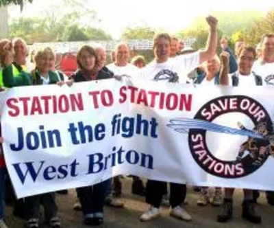 Julia Goldsworthy and Terrye Teverson marching with a save our fire stations banner