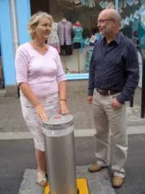 Terrye Teverson inspects Falmouth’s new traffic bollard with Chris Smith of Falmouth Town Forum